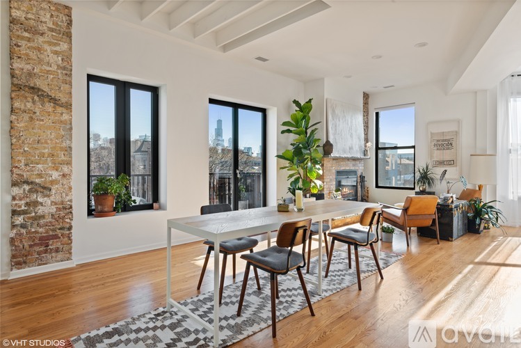 A dining room with a table and chairs.
