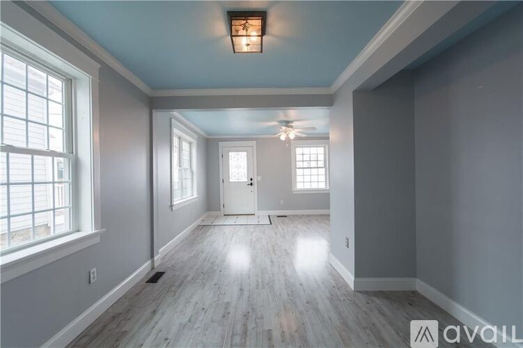 A room with a wooden floor and a white door.