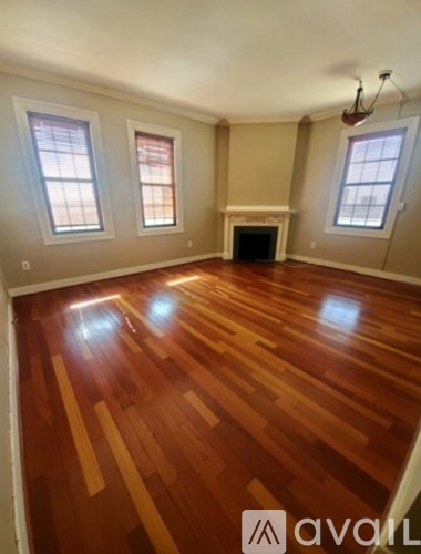 A room with wooden floors and a fireplace.