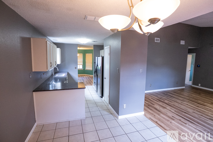 A kitchen area with a counter and cabinets.