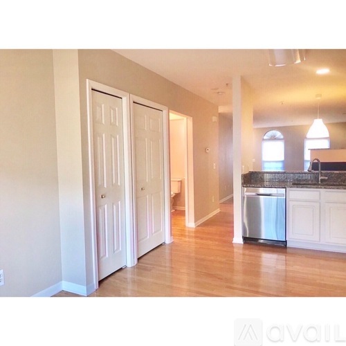 A kitchen area with a dishwasher and a sink.