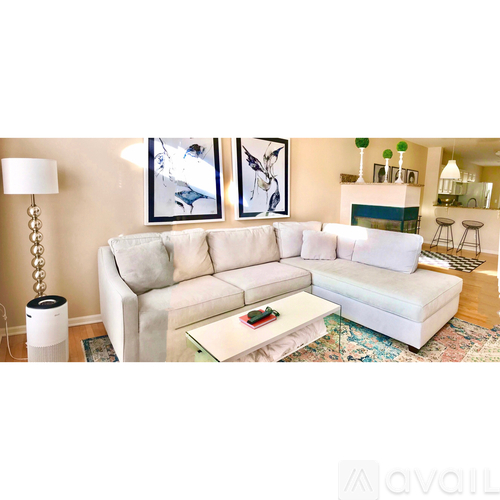 A living room with a white couch and a coffee table.