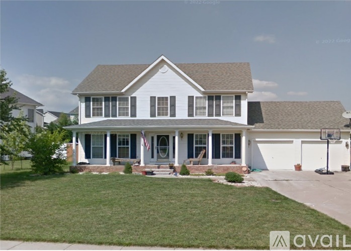 A two-story house with a front porch and a garage.