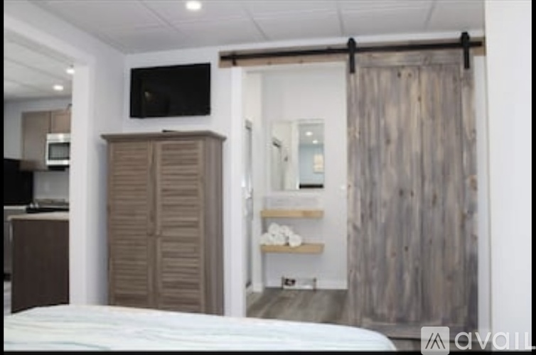A bedroom with a bed, a wardrobe, and a TV.