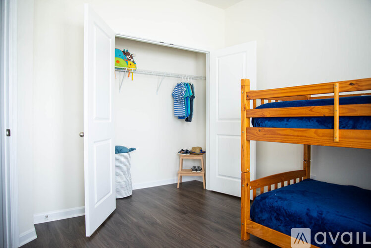 A bedroom with a bunk bed and a small table.
