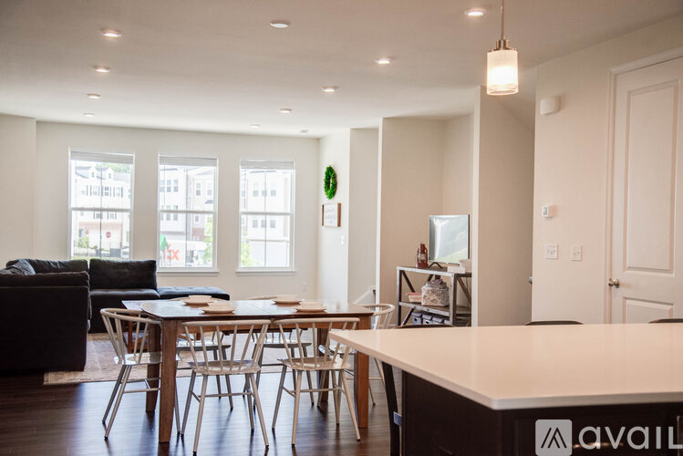 A modern dining room with a wooden table and chairs.
