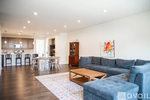 A living room with a grey couch and a wooden coffee table.