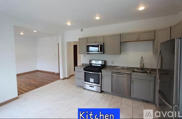 A kitchen with a refrigerator, stove, and microwave.