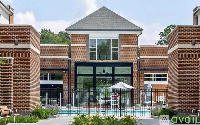 A pool area with a building in the background.