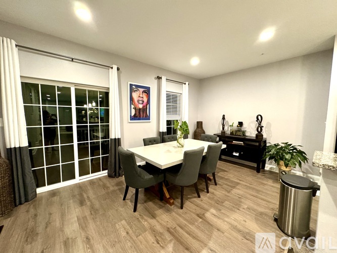 A dining room with a table set for six.