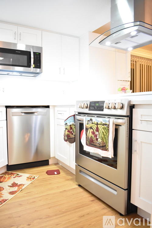 A kitchen with a stainless steel refrigerator and oven.