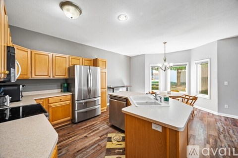 A kitchen with wooden cabinets and a white countertop.