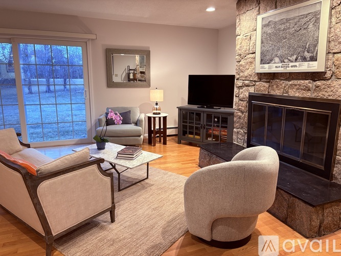 A living room with a fireplace and a chair.