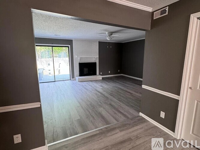A living room with a fireplace and sliding glass doors.