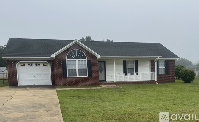A house with a brick facade and a white garage door.