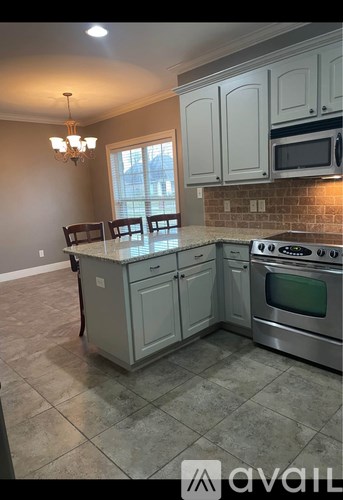 A kitchen with a stove top oven and a microwave above the stove.