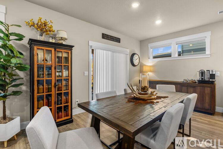 A dining room with a wooden table and chairs.