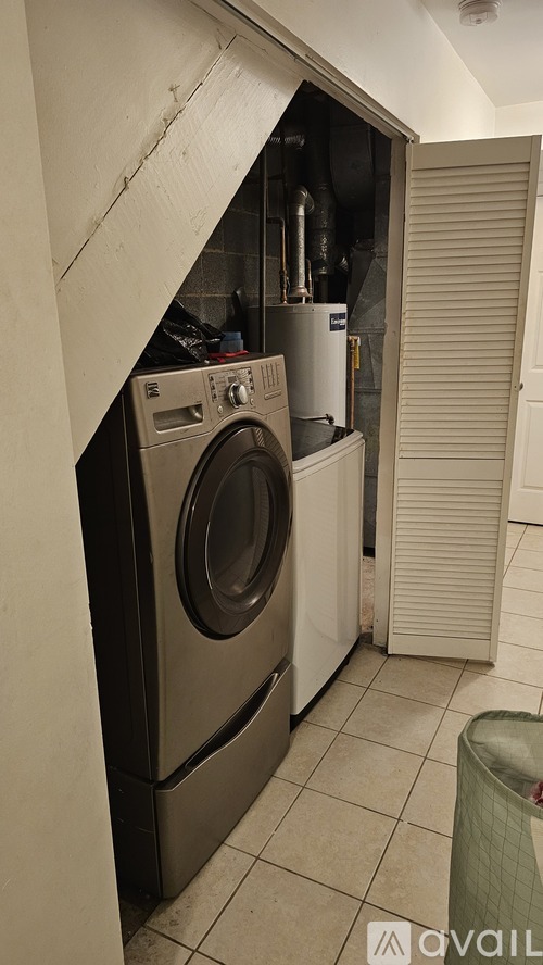 A washing machine is in a small room.