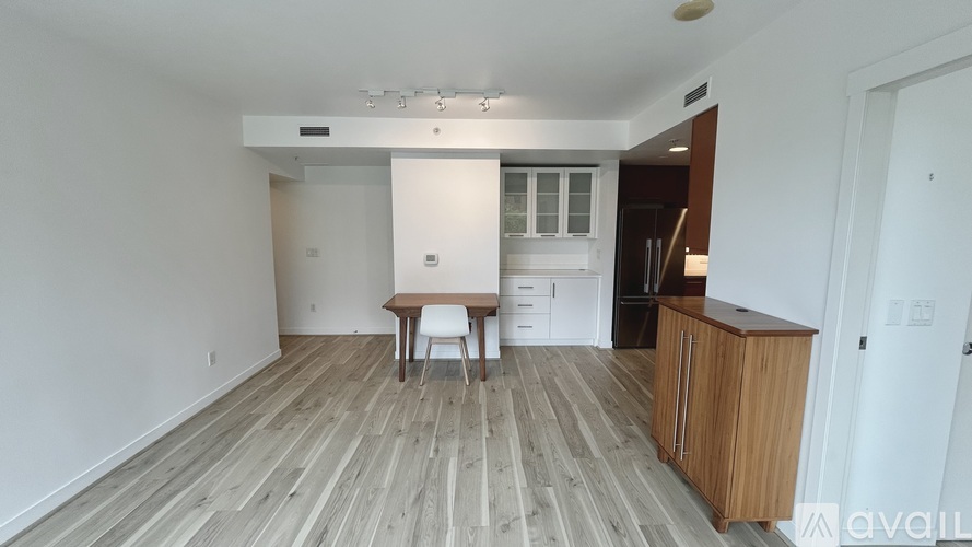 A room with wooden flooring and a white wall.