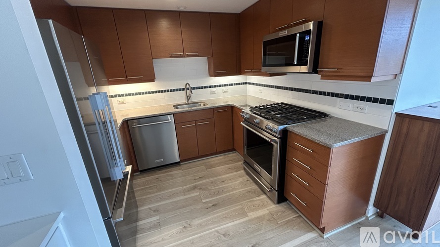 A kitchen with wooden cabinets and a white fridge.