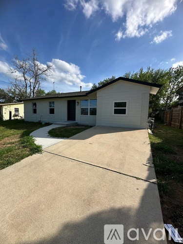 A small house with a driveway in front.