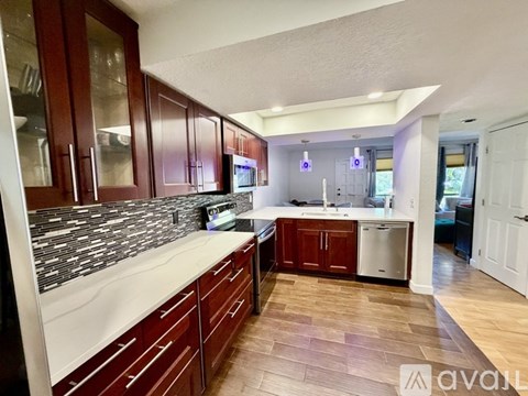 A kitchen with wooden cabinets and a white countertop.