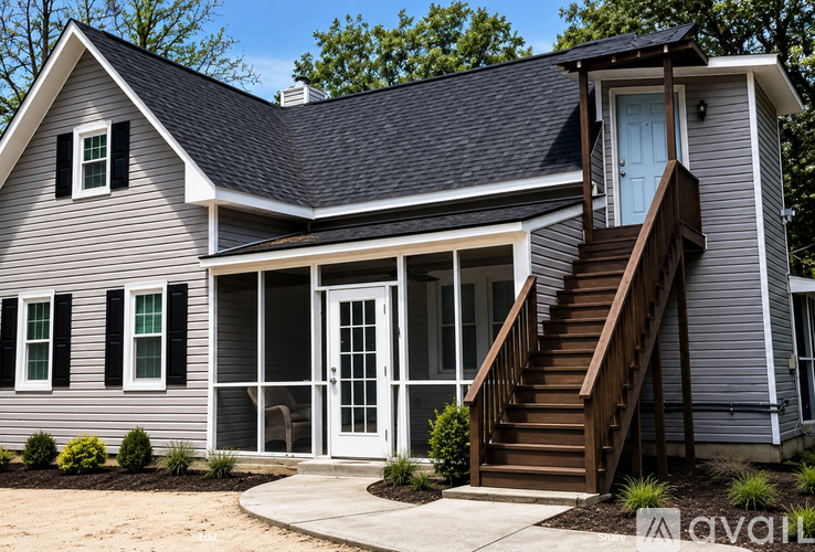 A house with a grey exterior and a blue door.