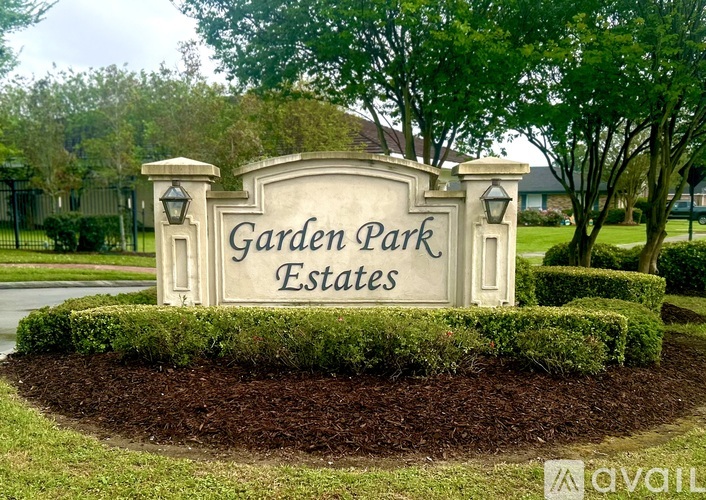 A sign for Garden Park Estates is displayed in front of a landscaped area.