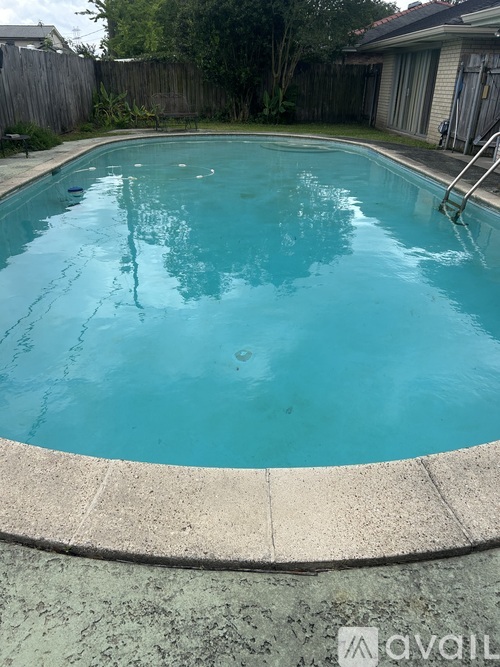 A small residential pool with a concrete edge.