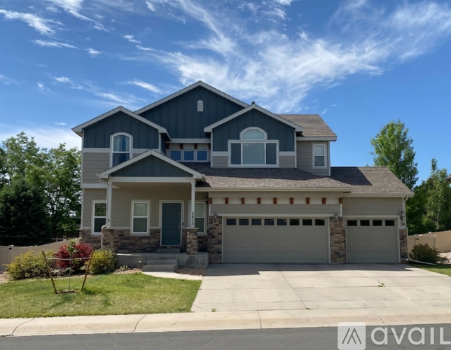 A two-story house with a garage is available for sale.