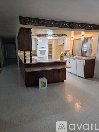 A kitchen with a wooden island in the middle of the room.