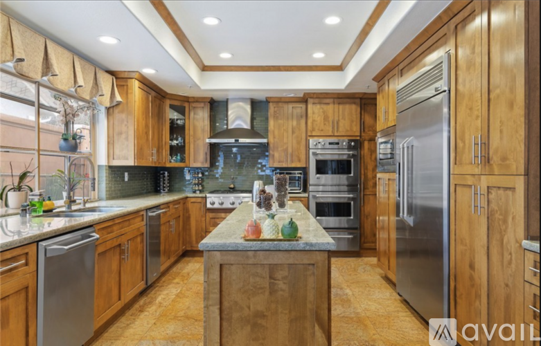 A kitchen with wooden cabinets and stainless steel appliances.
