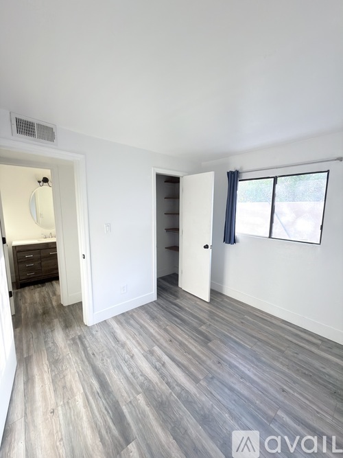 A room with a grey floor and white walls.