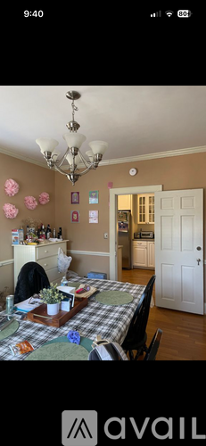 A dining room with a table set for a meal.