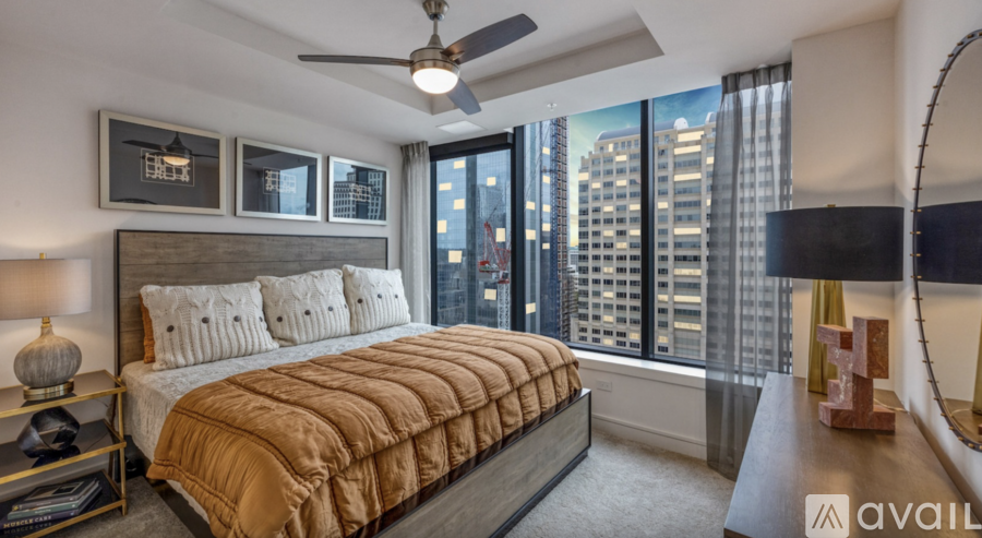 A bedroom with a large bed and a view of the city.