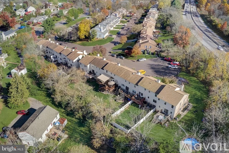 A bird's eye view of a residential area with houses and trees.