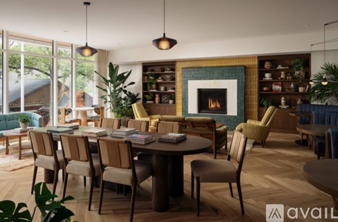 A modern living room with a fireplace and a dining table set up.