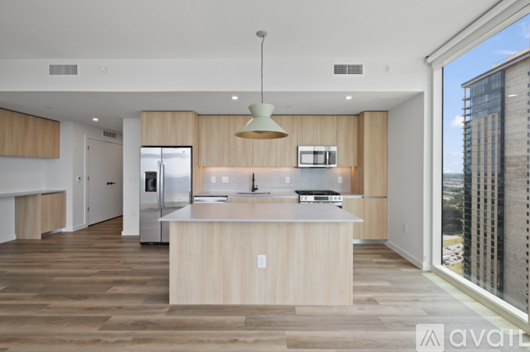 A modern kitchen with wooden cabinets and a central island.