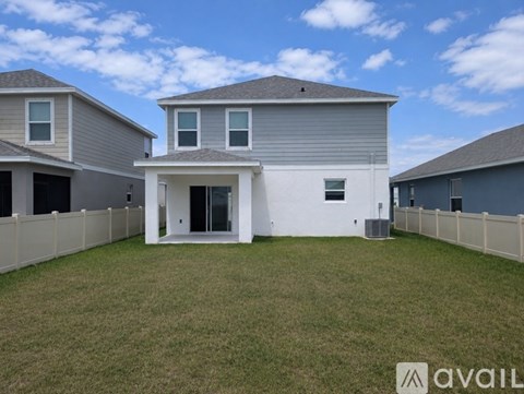 A house with a white front yard and a grey roof is available for sale.
