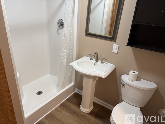 A white toilet sits next to a sink in a bathroom.