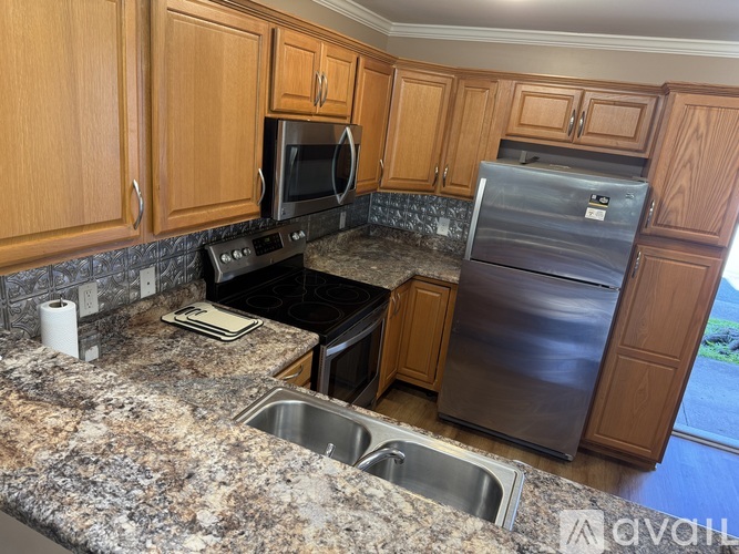 A kitchen with granite countertops and stainless steel appliances.