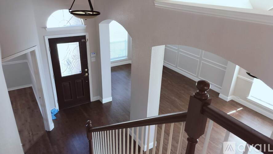 A view of a staircase with a chandelier hanging from the ceiling.