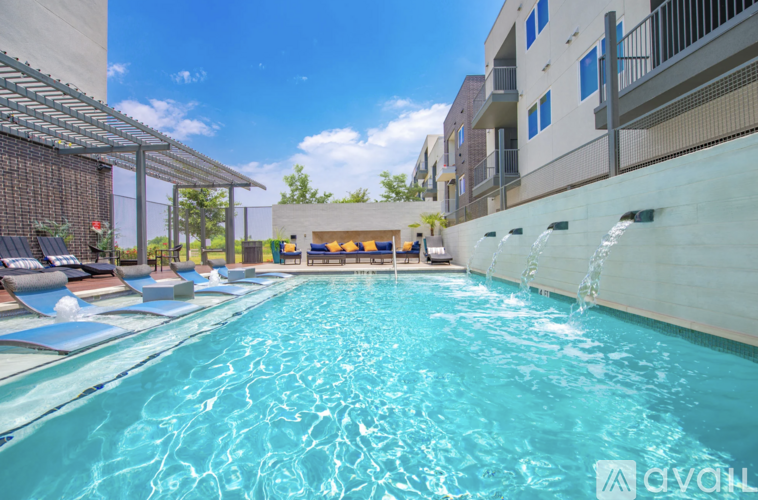 A swimming pool with water flowing from the side.