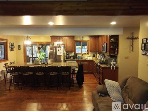 A kitchen with a dining table and chairs.
