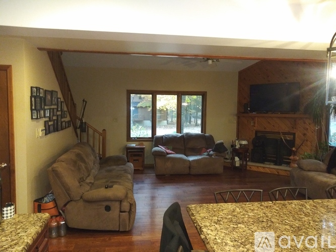 A living room with a fireplace and a TV.
