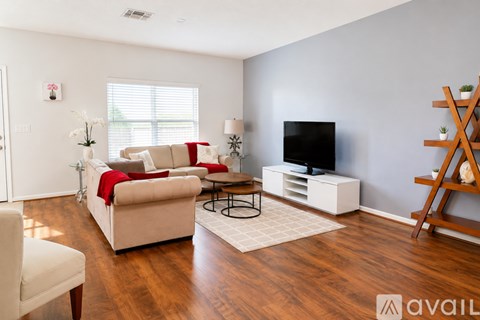 A living room with a white couch and a television.