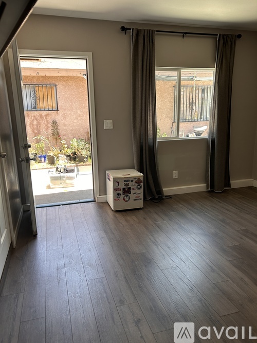 A room with a wooden floor and a white box on it.