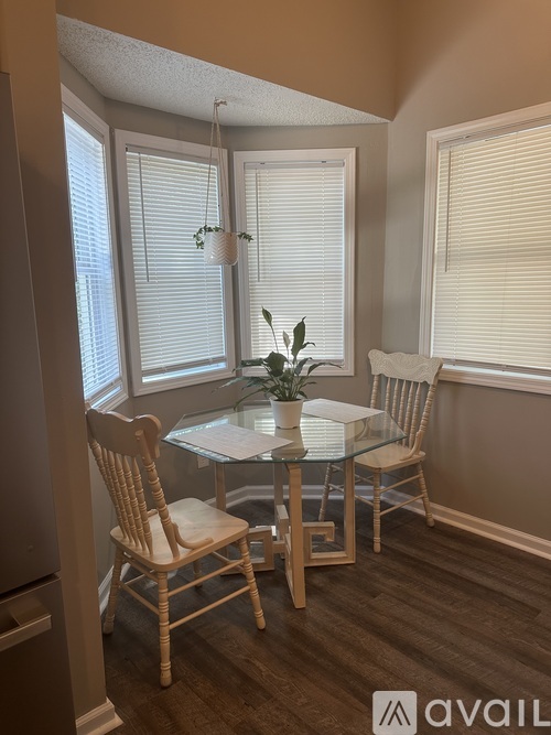 A dining room with a glass table and chairs.
