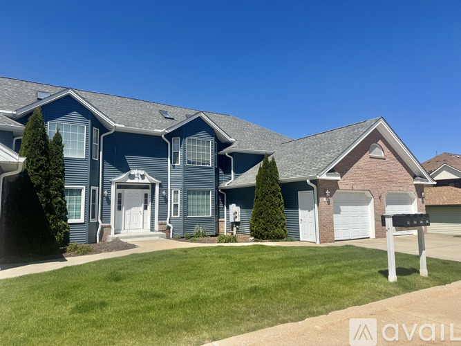 A blue house with a white door and windows is for sale.