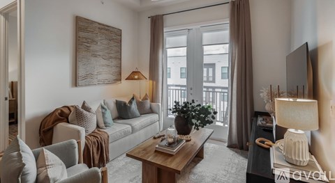 A living room with a grey couch, a wooden coffee table, and a painting on the wall.